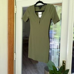 Olive green, ribbed cotton mini dress with a “v” snap closure detail.